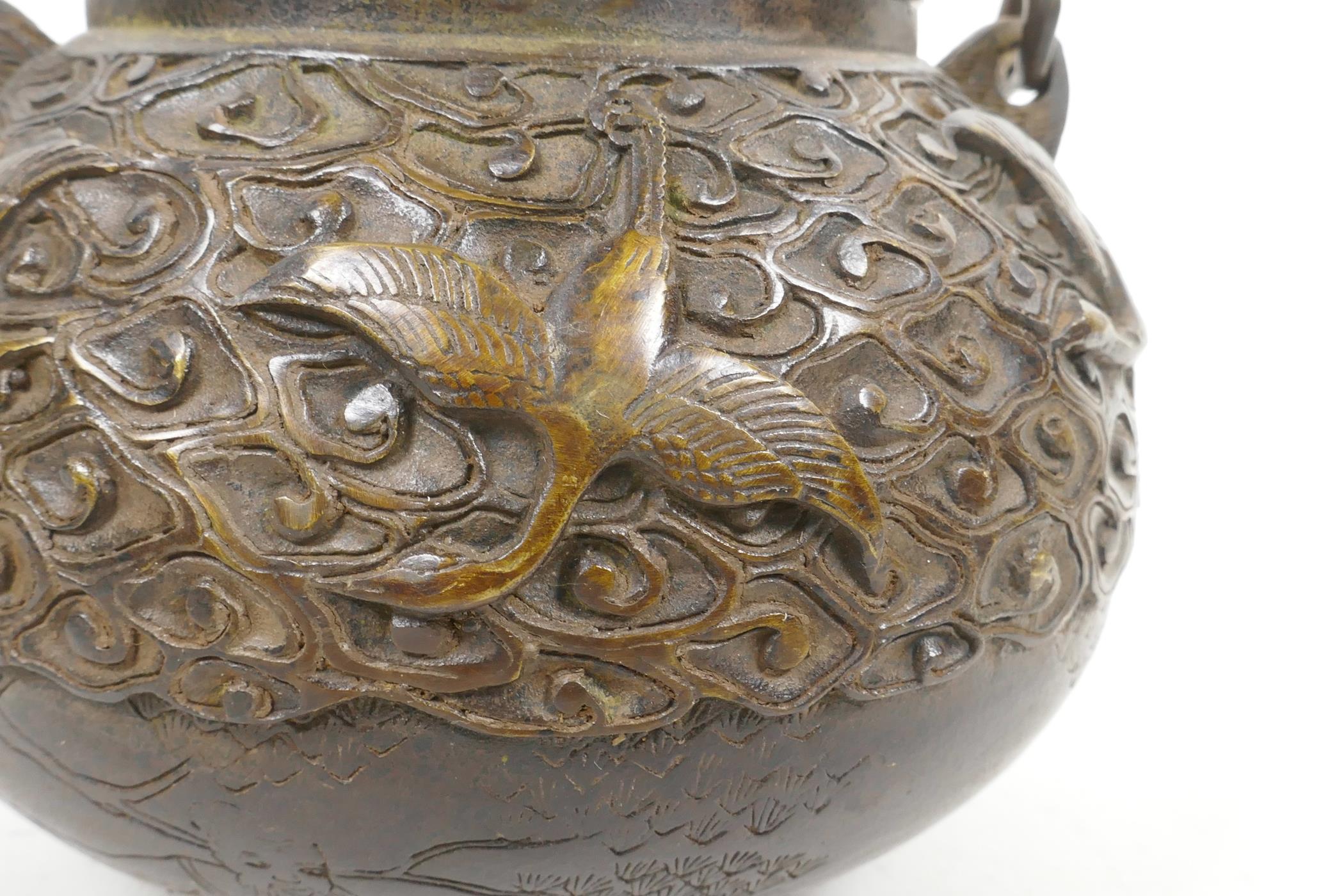 A Chinese bronze teapot with raised decoration of cranes in flight, four character mark to base, 5½" - Image 3 of 6