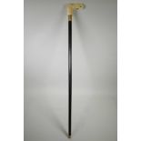 A walking stick with sectional bone handle, carved in the form of an elephant's head, 36" long