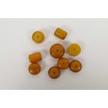 A quantity of loose amber style beads of assorted shapes