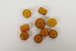 A quantity of loose amber style beads of assorted shapes