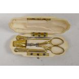 A faux ivory etui with gilt metal sewing kit including a Charles Horner designed Dorcas thimble,