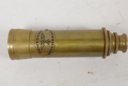 A brass cased three draw telescope marked Zeiss Germany, 6" long closed