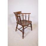 A C19th smokers bow armchair with an elm seat, 32" high