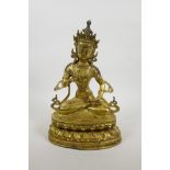 A Sino-Tibetan gilt bronze of Buddha seated on a lotus throne, 12½" high