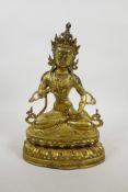 A Sino-Tibetan gilt bronze of Buddha seated on a lotus throne, 12½" high