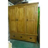 A contemporary oak triple door wardrobe, with two drawers, 63" x 23", 76" high