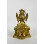 A Sino Tibetan filled gilt bronze of Buddha seated on a throne, impressed double vajra mark to base,