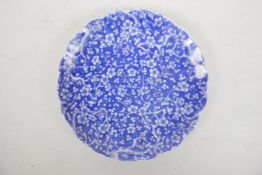 A Chinese porcelain plate with shaped edge and all over decoration of prunus and cracked ice, 8½?