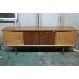 A mid century formica sideboard, with inverted front of two cupboards flanking a fall and three