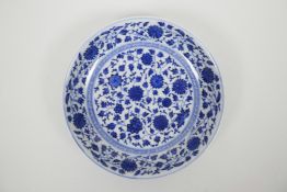 A Chinese blue and white porcelain shallow dish with scrolling floral decoration, seal mark to base,