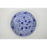 A Chinese blue and white porcelain shallow dish with scrolling floral decoration, seal mark to base,