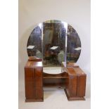 An Art Deco walnut dressing table with three drawers and cantilvevered cupboard doors with chromed