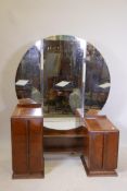 An Art Deco walnut dressing table with three drawers and cantilvevered cupboard doors with chromed