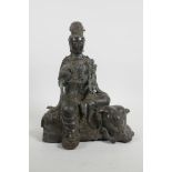 A Chinese bronze Quan Yin seated on an elephant and holding a ruyi, impressed six character mark