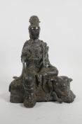 A Chinese bronze Quan Yin seated on an elephant and holding a ruyi, impressed six character mark