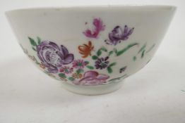 An C18th Chinese porcelain rice bowl painted with flowers and insects in bright enamels, 4" diameter