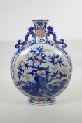 A Chinese blue, white and red porcelain moon flask with two handles, decorated with bats and a peach