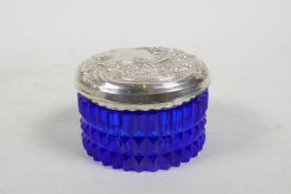 An Art Nouveau style blue glass and sterling silver topped trinket box, the lid with repousse