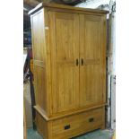 A contemporary oak wardrobe with two doors over a single drawer, 43" x 23", 76" high