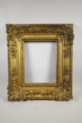 A C19th giltwood and composition picture frame, with shell and floral decoration, broad section