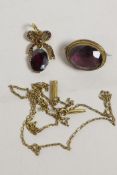 A yellow metal pendant set with a garnet, and a brooch