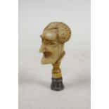 A C19th carved ivory seal handle of possibly the Duke of Wellington, with a coloured crystal set