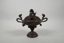 A Chinese copper two handled censer and pierced cover, decorated with dragons and flowers, with a fo