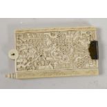 A C19th Chinese ivory dance card holder with carved decoration of figures in a garden, seven