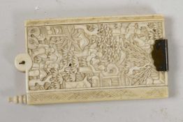 A C19th Chinese ivory dance card holder with carved decoration of figures in a garden, seven