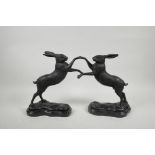 A pair of bronzed metal boxing hares, 11" high