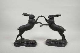 A pair of bronzed metal boxing hares, 11" high