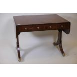 A C19th crossbanded mahogany centre table on end supports with drawers and dummy drawers to each