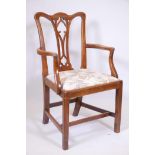 An C18th/C19th walnut Chippendale elbow chair with pierced gothic splat back, raised on square