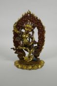 A Sino Tibetan bronze figure of a wrathful deity with cold painted highlights, 10" high