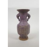 A Chinese amethyst glazed pottery vase with chased and gilt character decoration, 8½" high