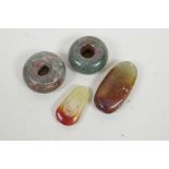 Four soapstone pendants of various shapes, one with carved Buddha decoration, 3" largest