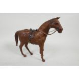 An antique leather model horse with glass eyes, 9" high