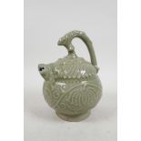 A Chinese celadon glazed pottery water dropper with raised floral decoration, the handle in the form