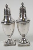A pair of classical urn style hallmarked silver salt and pepper pots, hallmarked Sheffield 1900,