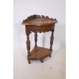An oak two tier corner table with carved friezes and shaped galley top, 17" x 32"