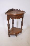 An oak two tier corner table with carved friezes and shaped galley top, 17" x 32"