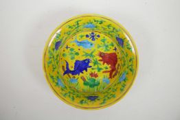 A Chinese yellow ground porcelain steep sided dish with polychrome decoration of carp in a lotus