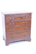 A mahogany bachelor's chest with brushing slide over four graduated drawers, fitted with brass