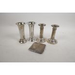 A pair of silver candlesticks, hallmarked London 1906, 4½" high, together with a pair of silver