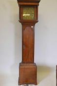 A C18th oak long case clock, the brass dial with engraved chapter ring and enamelled Roman numerals,