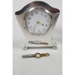 An Art Nouveau hallmarked silver desk clock with key, hallmarked 1905