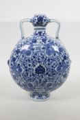 A Chinese blue and white porcelain garlic head flask with two handles and decorated with a