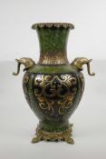 A Chinese mottled green ground pottery vase with ormolu style mounts and elephant mask handles,