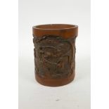 A Chinese carved bamboo brush pot decorated with figures in a landscape, 6½" high
