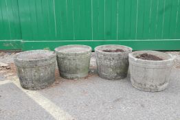 A set of four concrete half barrel planters, 16" high x 12" diameter